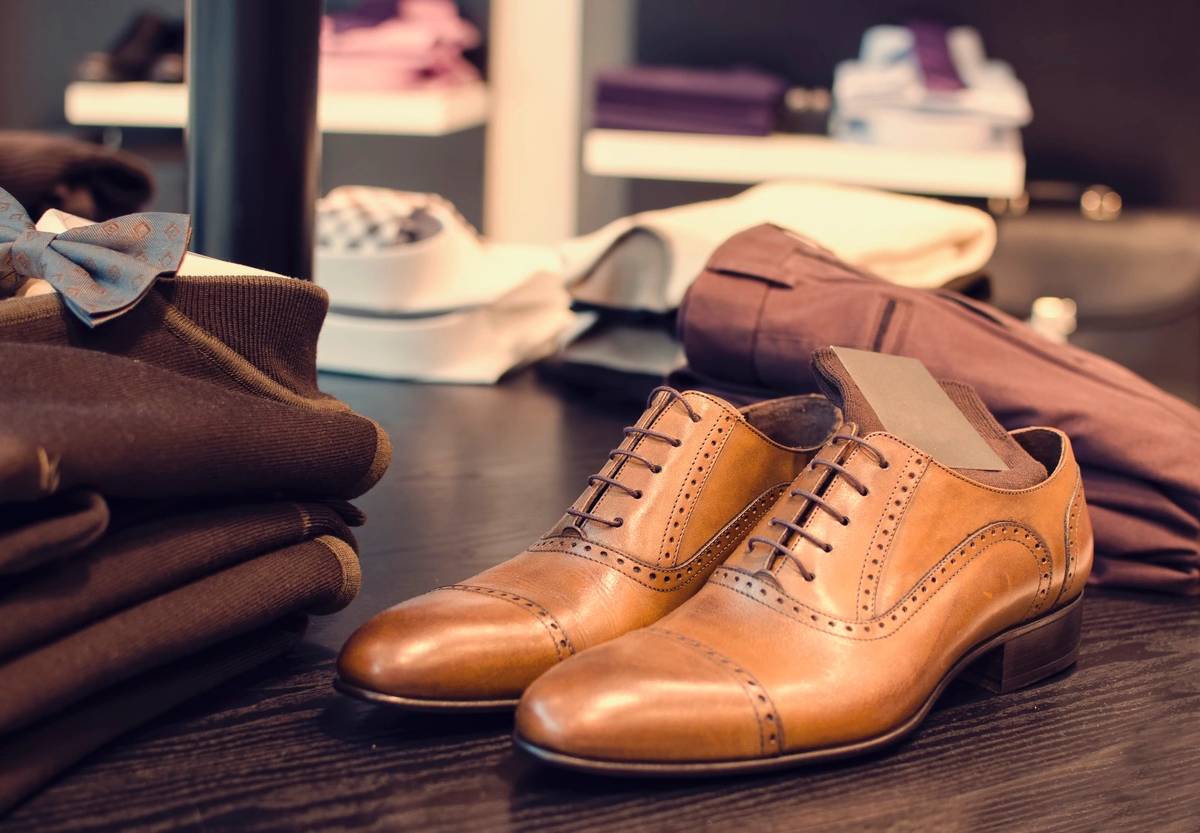 Close-up of worn brown leather shoes with loose laces.
