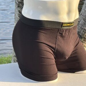 Mannequin wearing black boxer briefs outdoors.
